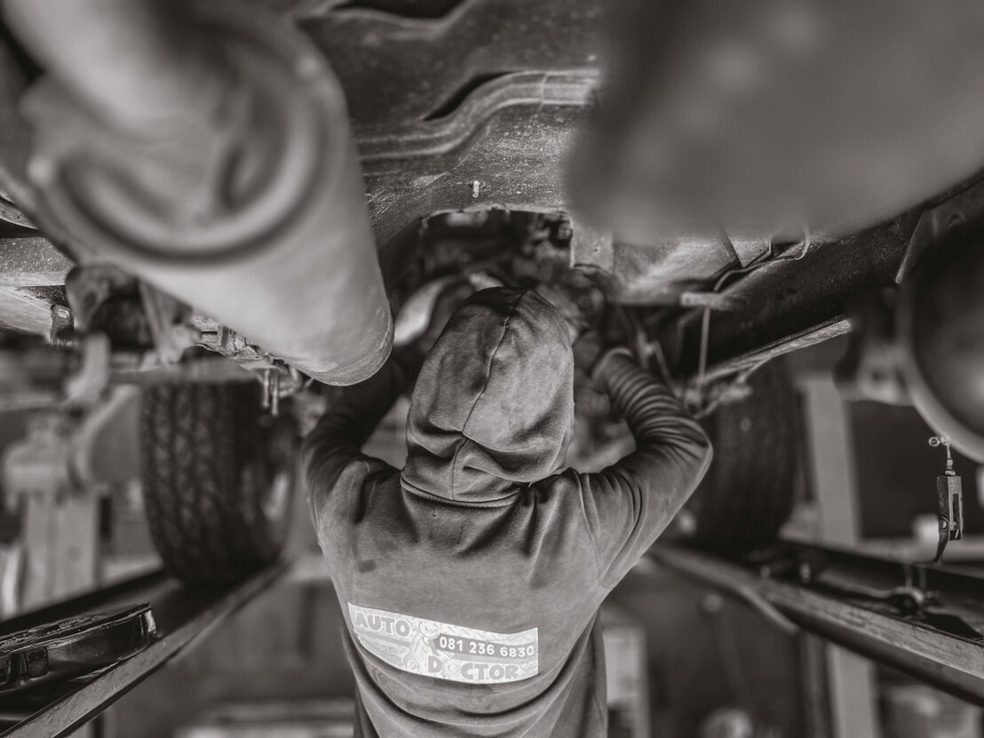 Mechanic working on a vehicle at the EPCarGuy service bay